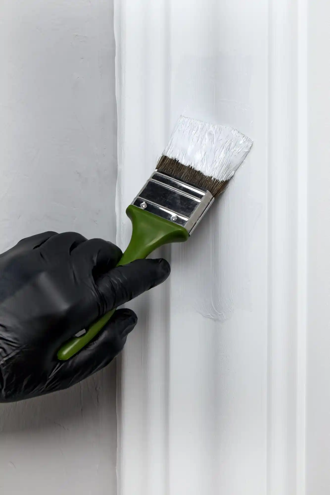 Professional painter applying coat on Melbourne home wall with proper technique